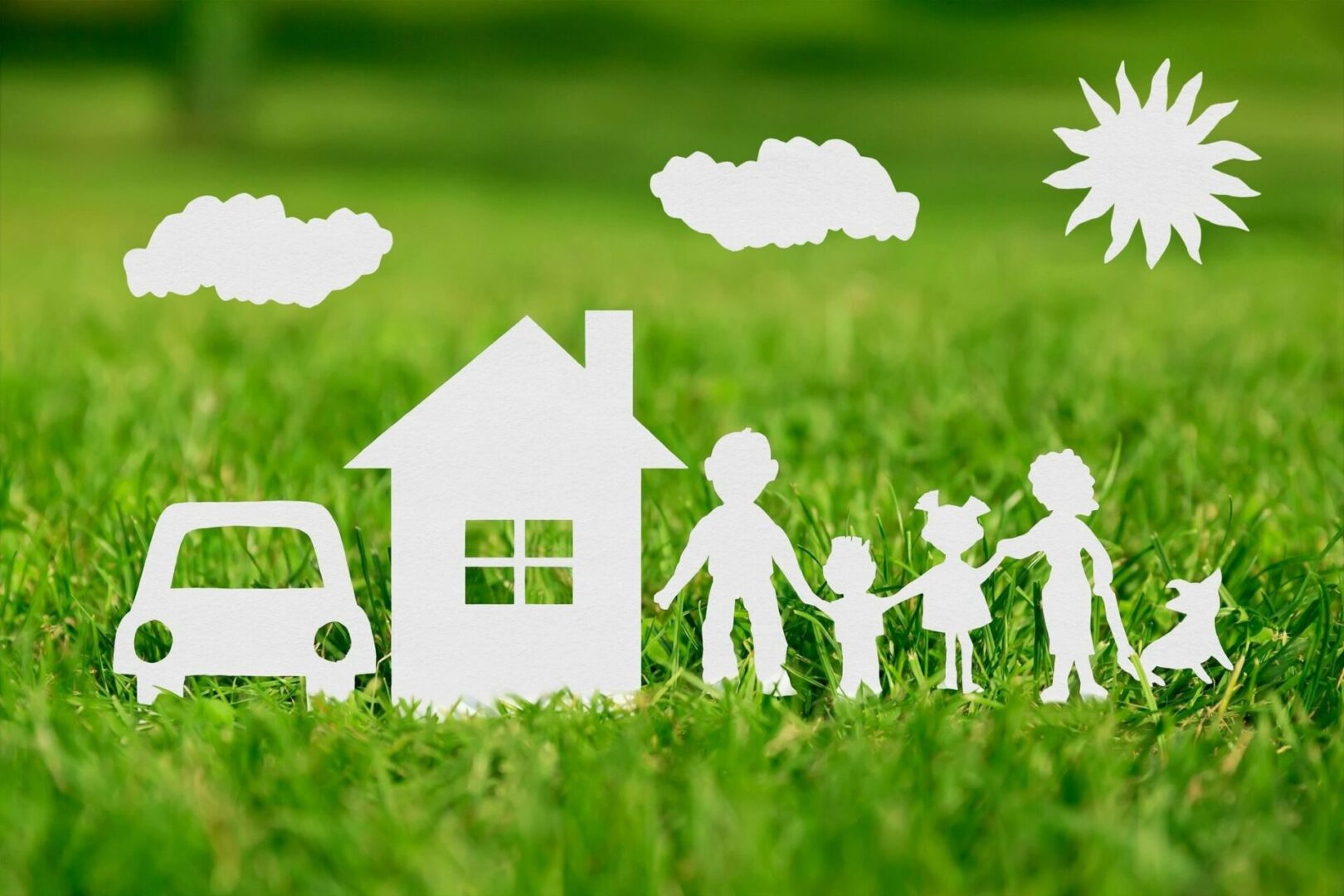 Paper Cut of Family With House and Car on Green Grass