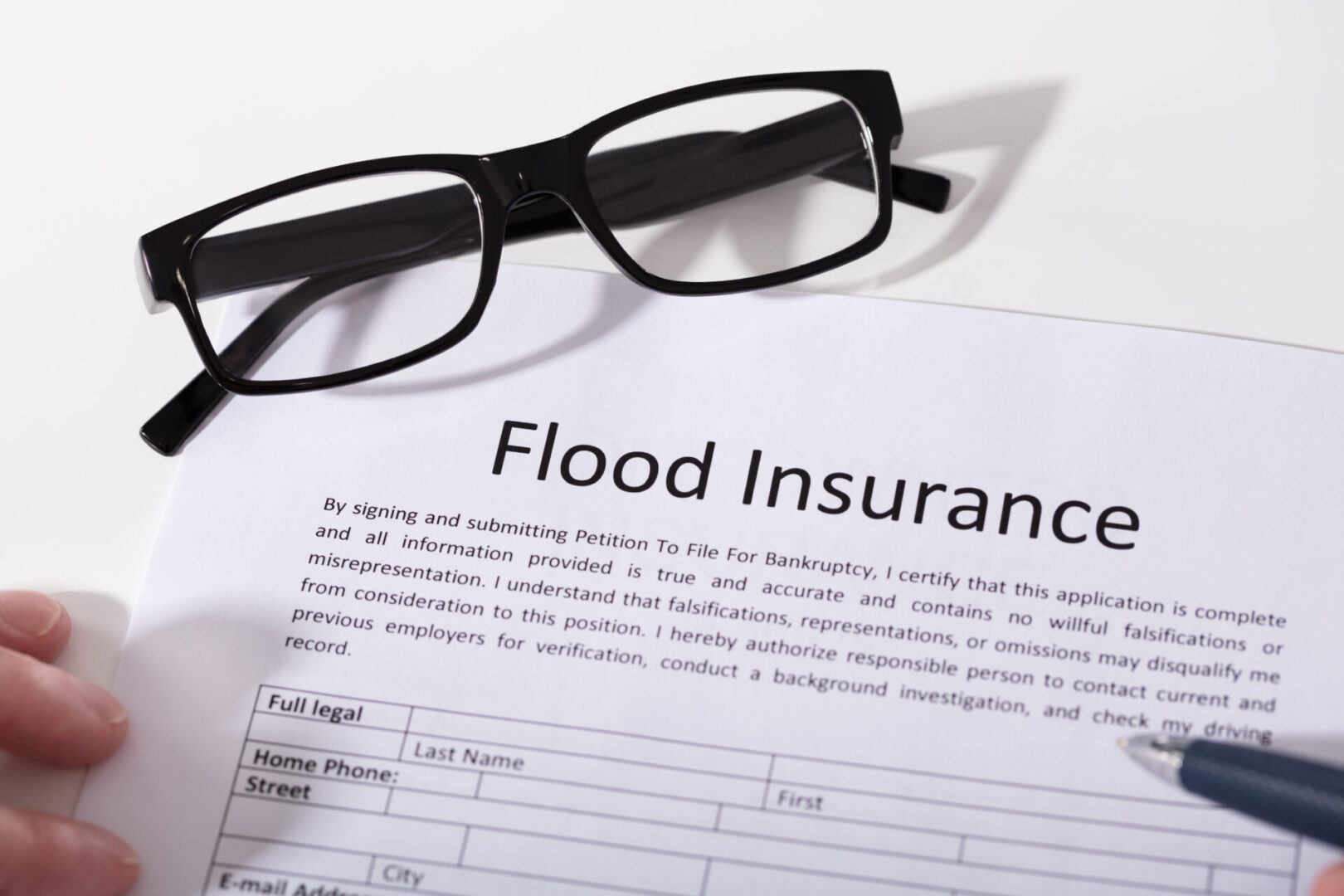 Elevated View Of Flood Insurance Form And Spectacles